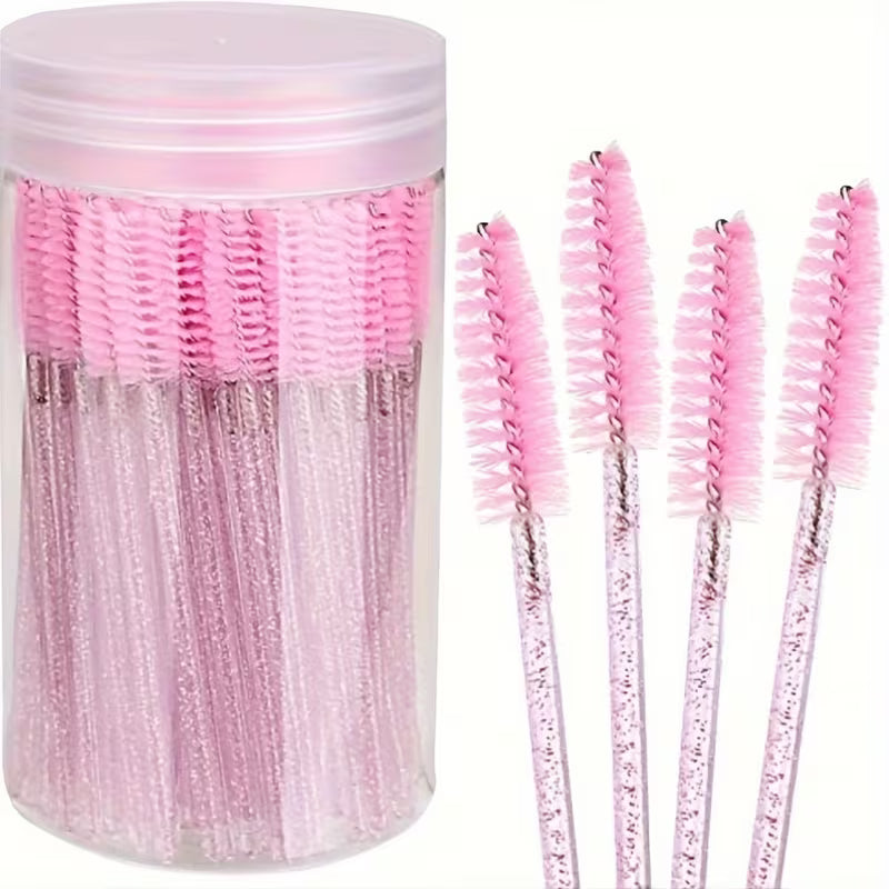 Container of disposable pink mascara/eyebrow brushes with glitter handles, five wands visible