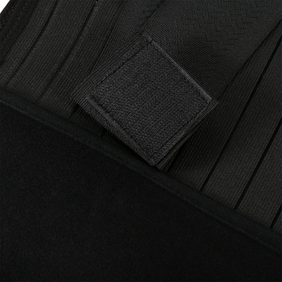Close-up of black corset belt fabric and textured adjustable strap panel
