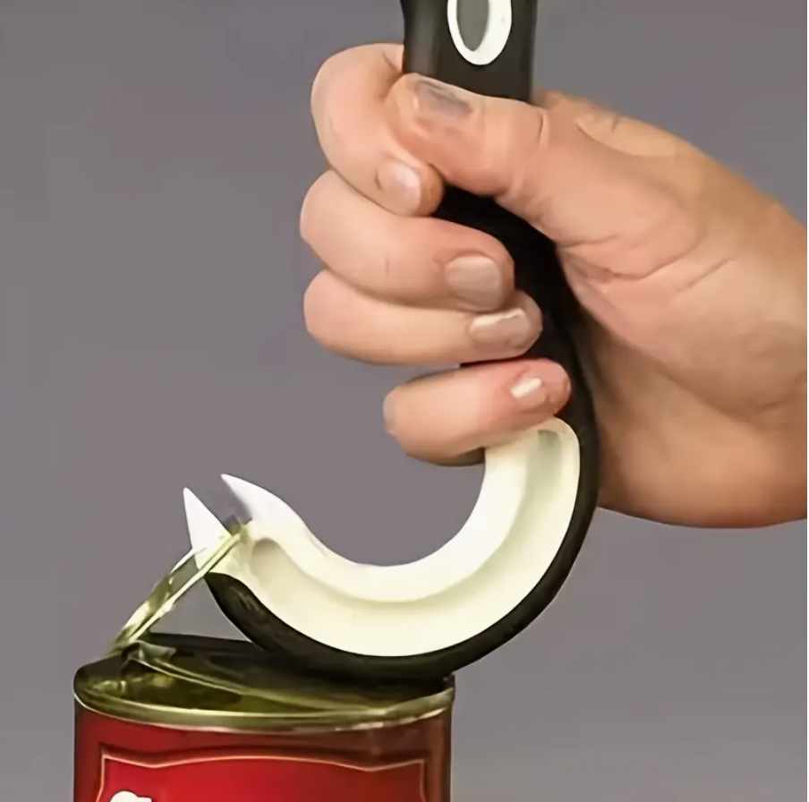 Hand holding black can opener above the can lid, curved white hook visible.