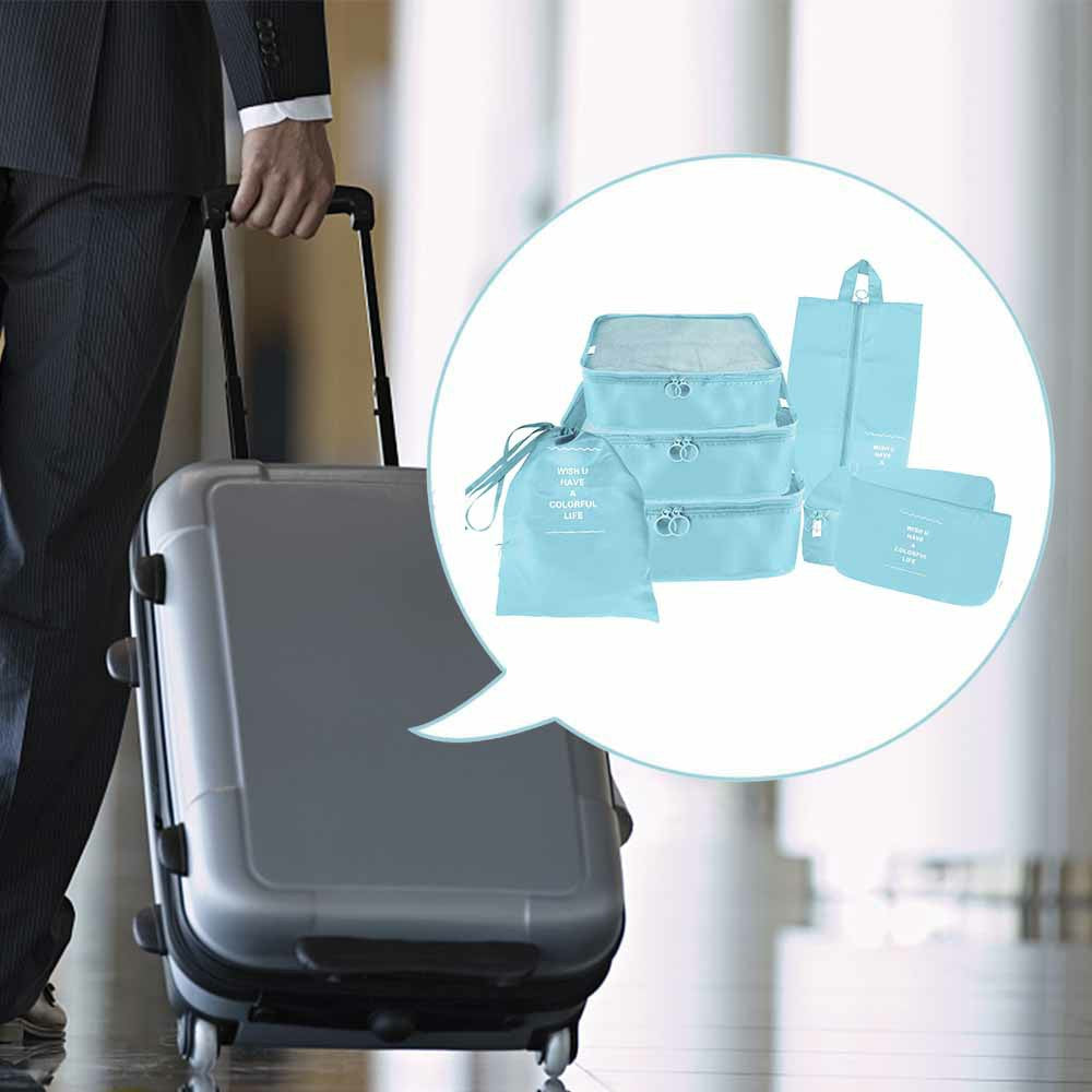 Blue waterproof packing cubes set shown next to a rolling suitcase