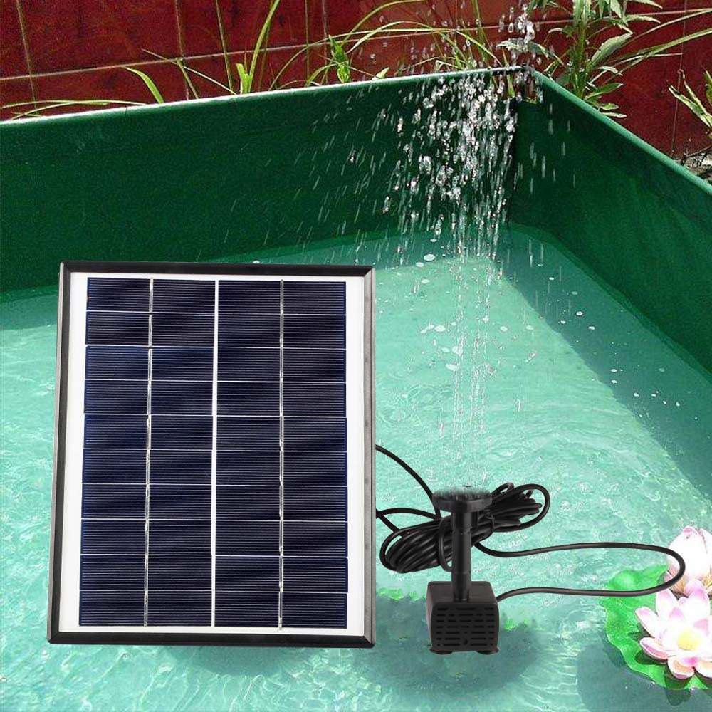 Solar panel and black submersible pump in a pond fountain setting with water spray