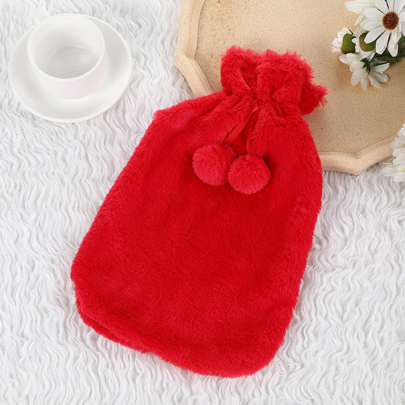 Large red plush hot water bottle cover with pom-pom detail