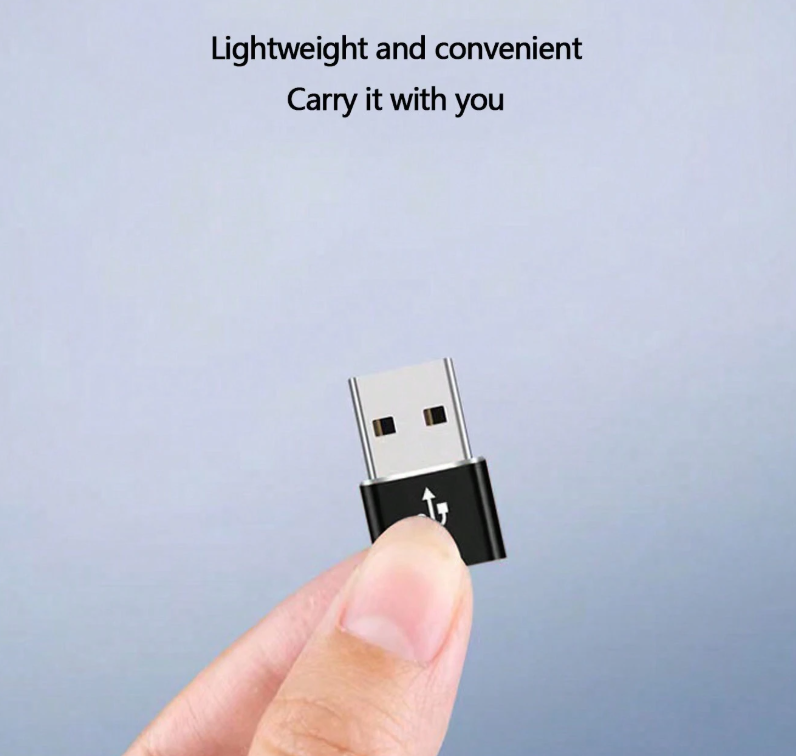 USB-A to Type-C adapter with black connector housing, held in hand, metal finish