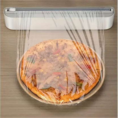 Compact white cling film dispenser box holding a round food wrap roll