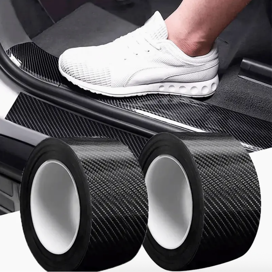 Two rolls of dark carbon fiber protection film with white release liner and black edges