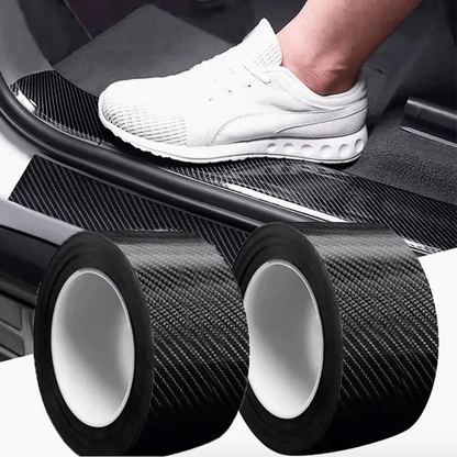 Two rolls of dark carbon fiber protection film with white release liner and black edges