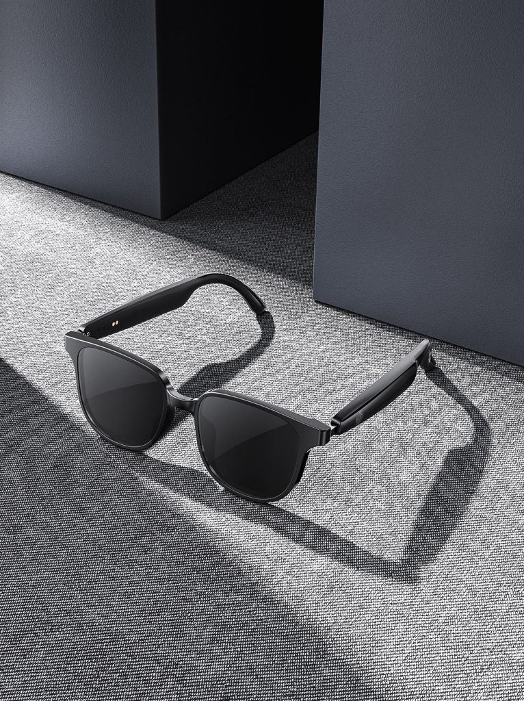 Black open-ear Bluetooth audio sunglasses with curved temples and dark lenses