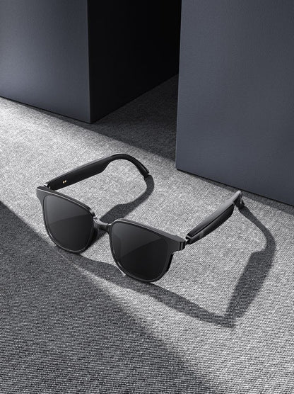Black open-ear Bluetooth audio sunglasses with curved temples and dark lenses