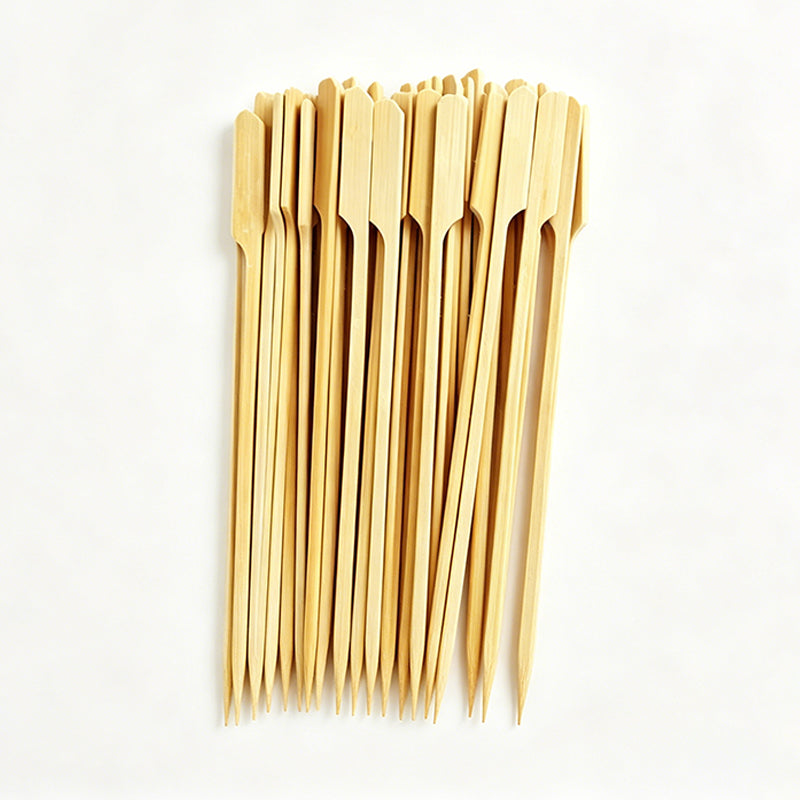 Bundle of long light bamboo BBQ skewers with pointed tips, ready for grilling