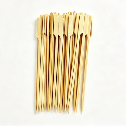 Bundle of long light bamboo BBQ skewers with pointed tips, ready for grilling