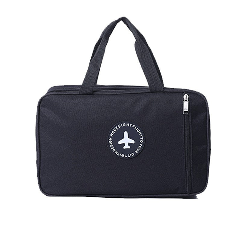Black wet and dry toiletry bag with top handles, front zipper, and round logo patch.