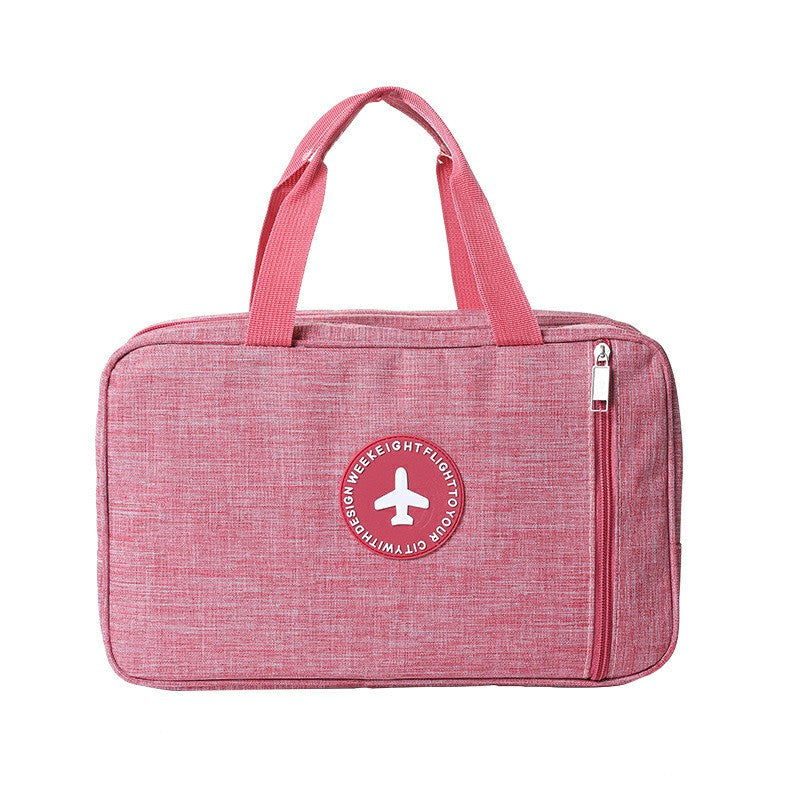 Pink zippered wet and dry toiletry bag with carry handle, small front logo patch.