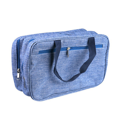 Blue wet and dry toiletry bag with carry strap, side zippers, and structured rectangular body.