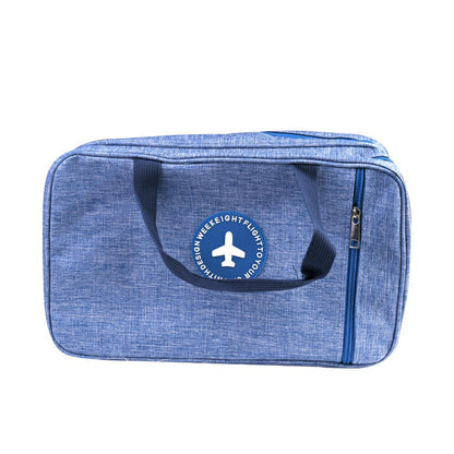 Light blue toiletry wash bag with front logo, black handle strap, and zip closure