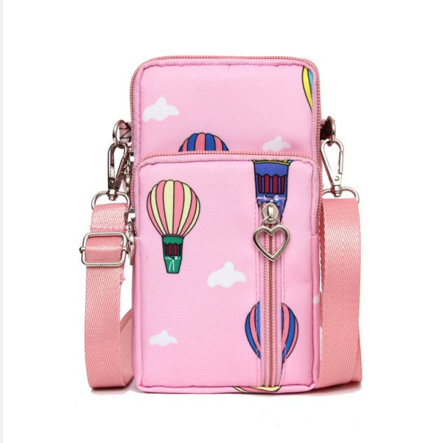 Pink mini cross-body phone bag with zipper, colorful hot-air balloon print