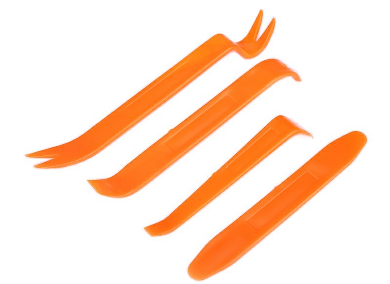 Set of four orange plastic pry tools with curved tips for removing car panels