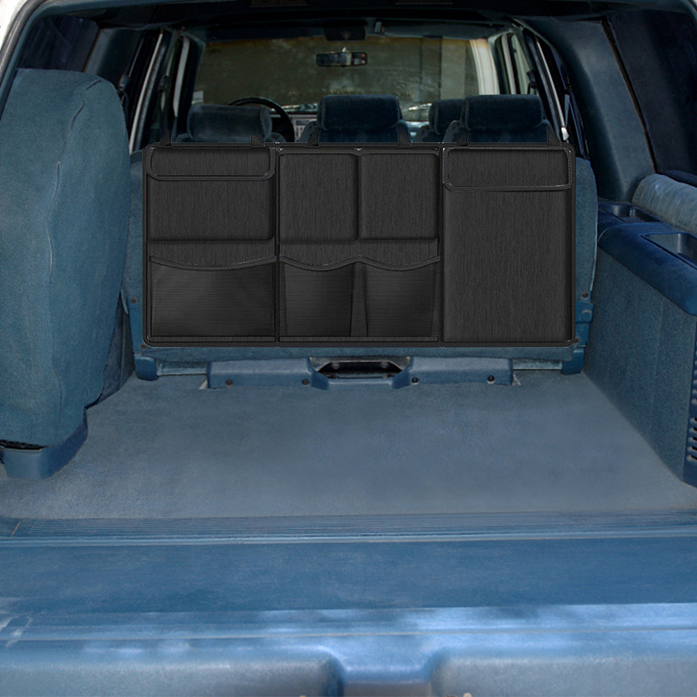 Black seat-back hanging storage organizer with multiple front compartments and zippered panels