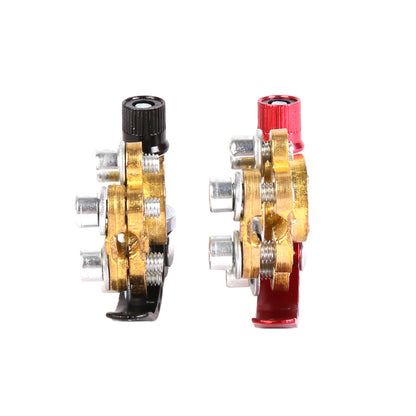 Pair of battery terminal clamps, one red and one black, with brass base and silver bolts