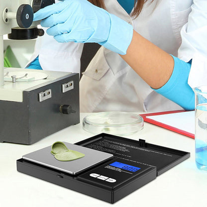 Digital pocket mini jewellery weighing scale on work surface with metal weighing platform