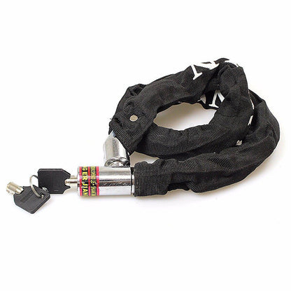 Black fabric-covered bicycle chain lock with keys, laid flat with metal lock body