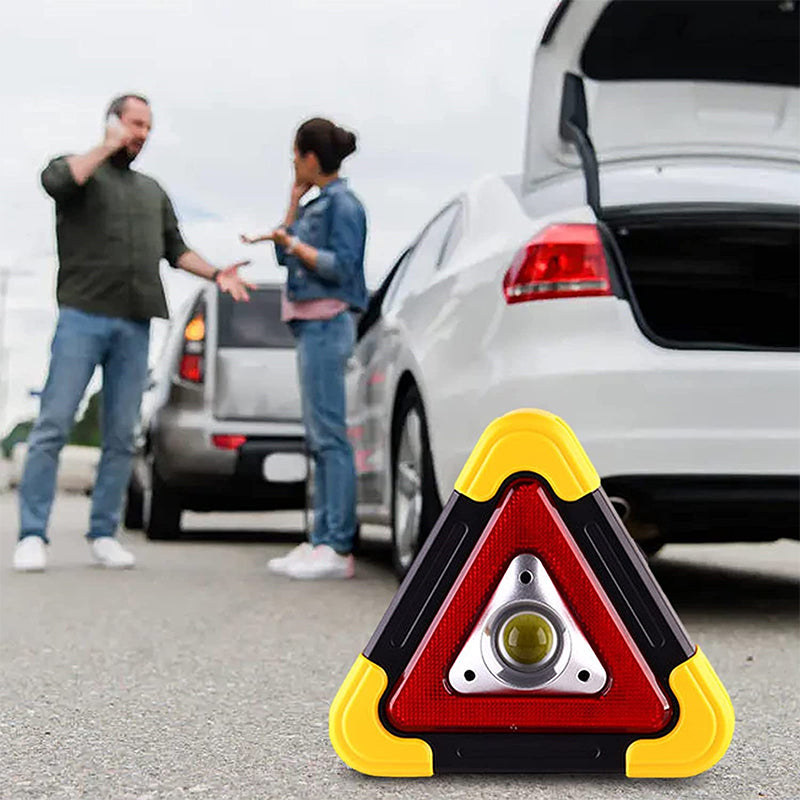 Car emergency warning triangle light standing by car trunk, red reflective triangle