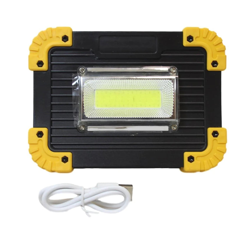 Front view of portable COB work light with bright yellow LED in clear cover, black and yellow