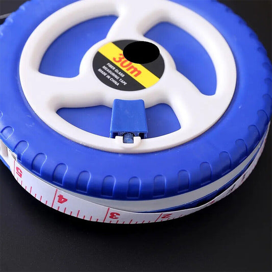 Blue and white fiberglass tape measure reel with partial measuring tape edge visible