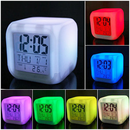 Color-changing cube LED alarm clock showing time in multiple glowing colors