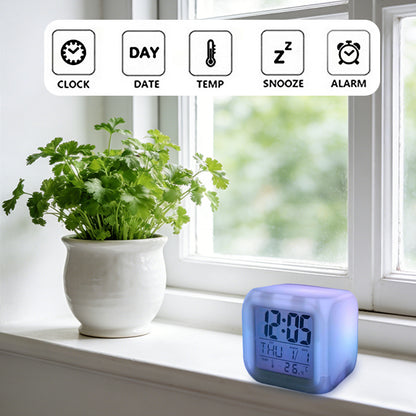 White cube digital alarm clock top buttons with icons for clock, date, temp, snooze, alarm