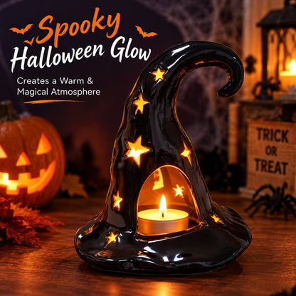 Black ceramic witch hat candle holder with glowing candle and star decorations