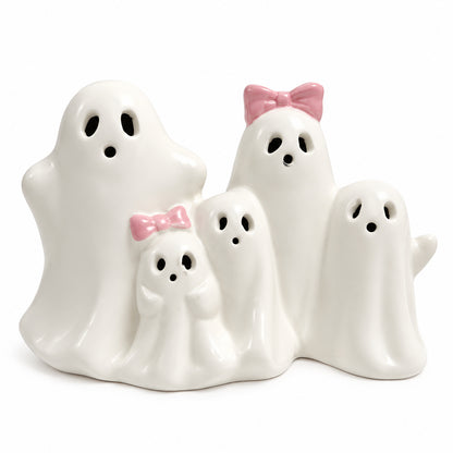 Ceramic ghost figurine set with black eyes, matte white bodies, and pink bow accessories