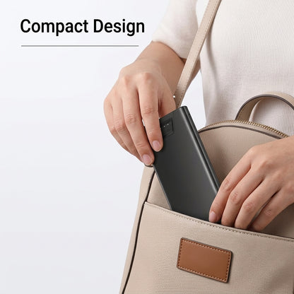 Matte black portable power bank placed in a bag pocket