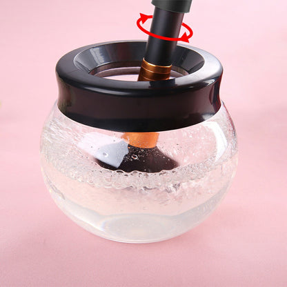 Clear container with black lid and copper nozzle stirring through cleaning water