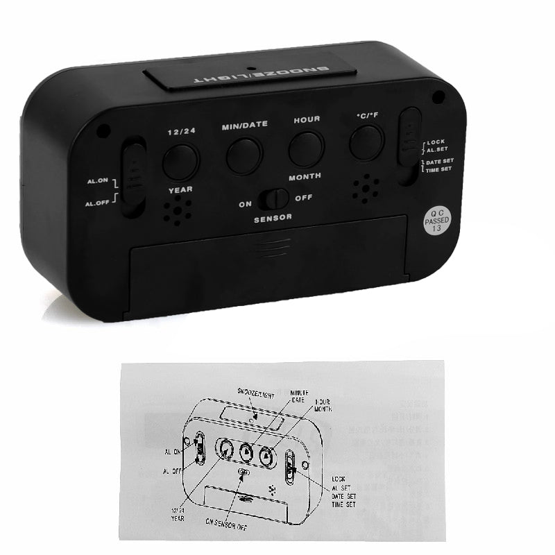 Black LED digital alarm clock underside with control buttons, sensor area, and lock switch