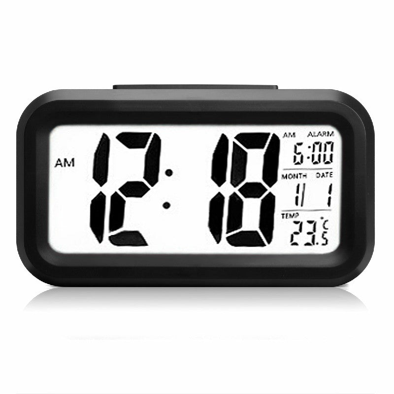 Black LED digital alarm clock front showing time, month, date, and temperature in bright digits