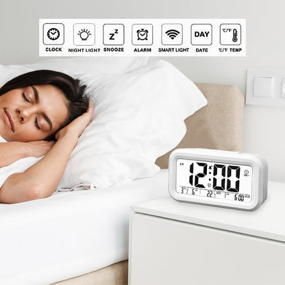 White digital LED alarm clock showing time, date, and temperature on the display