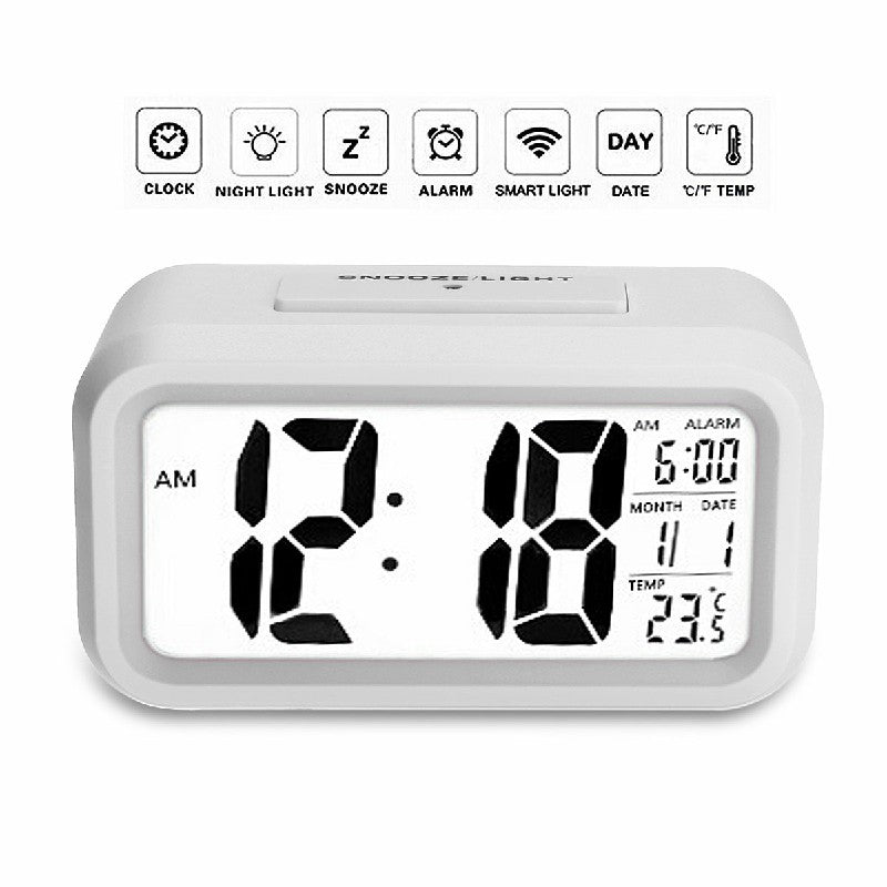 White digital LED alarm clock front view with time, AM/PM, date, and temperature