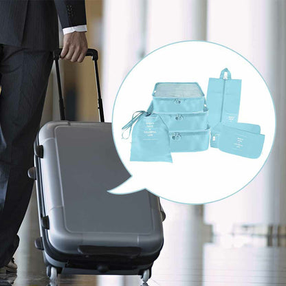 Blue waterproof packing cubes set shown next to a rolling suitcase