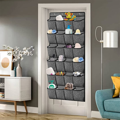 Hanging shoe organizer with gray fabric pockets, hanging over a door opening with metal hooks