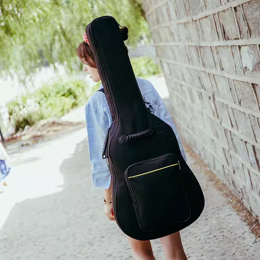 Black padded guitar gig bag on shoulder, front storage pocket and zip closure