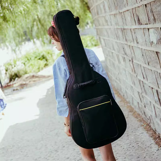 Black padded guitar gig bag on shoulder, front storage pocket and zip closure