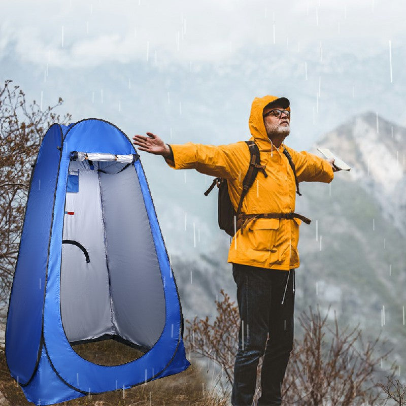 Blue pop-up shower changing tent with open front privacy panel in rain outdoors