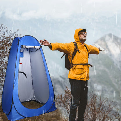Blue pop-up shower changing tent with open front privacy panel in rain outdoors