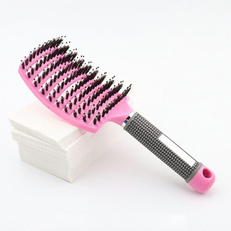 Pink curved paddle detangling brush with mixed black bristles and speckled handle