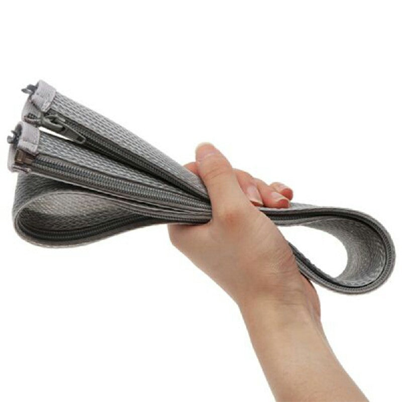 Grey braided cable sleeve organizer with zipper opening, gripped by a hand