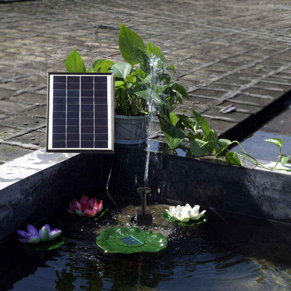 Solar panel and black water pump spraying water for pond fountain use