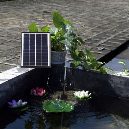 Solar panel and black water pump spraying water for pond fountain use