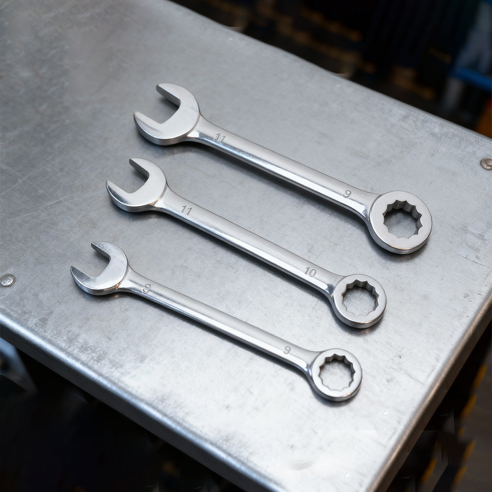 Three small combination wrenches with open end and box end on a metal tray