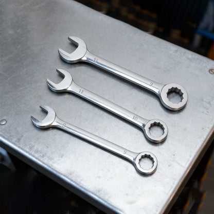 Three small combination wrenches with open end and box end on a metal tray