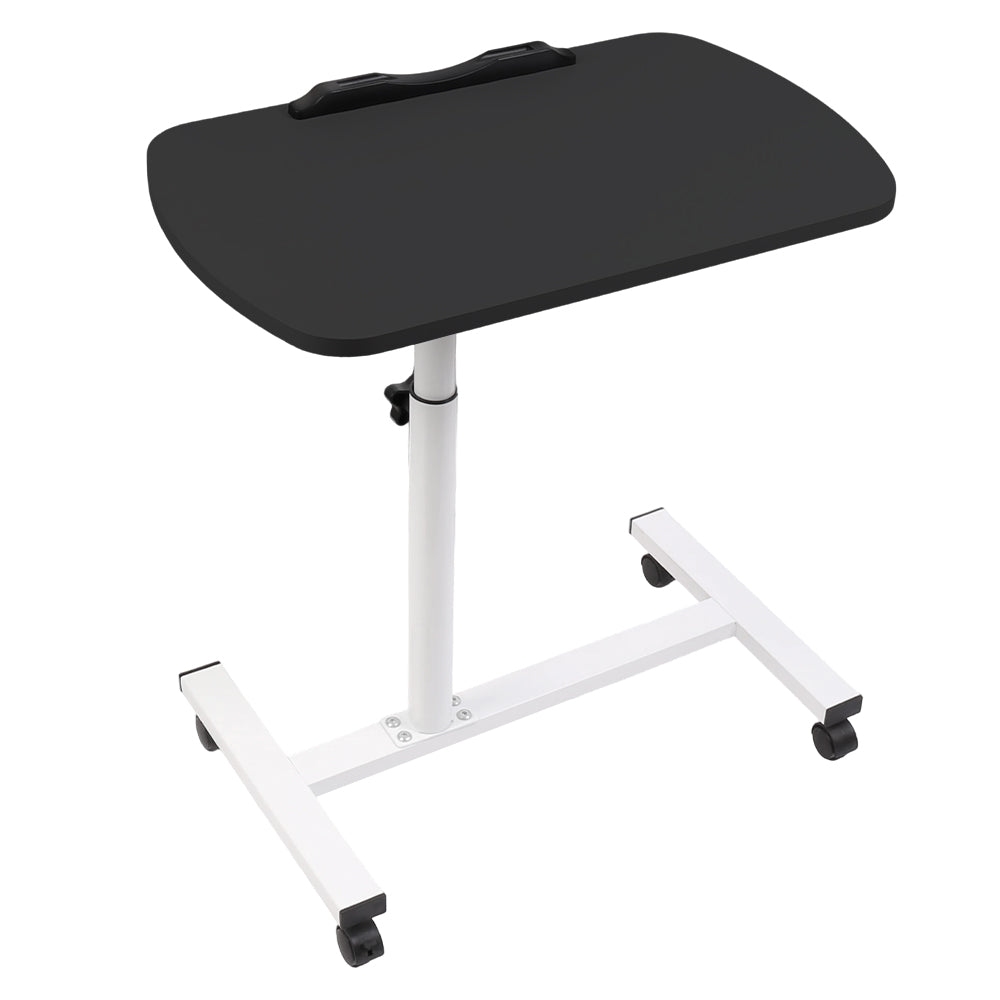 Adjustable overbed table with black tabletop, white frame, and four casters